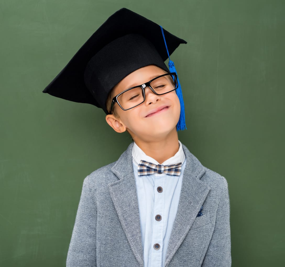Happy schoolboy in a graduation cap