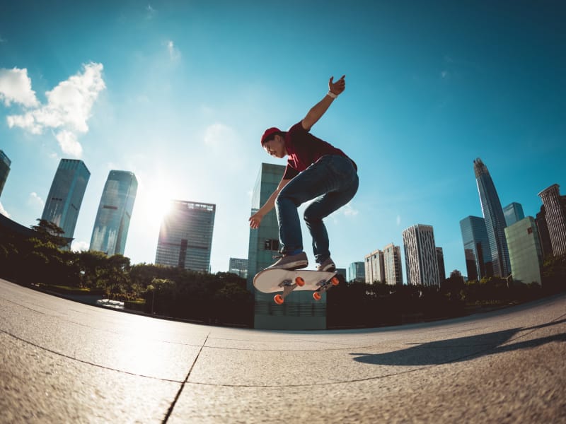 Person skateboarding in the sunlight in a city